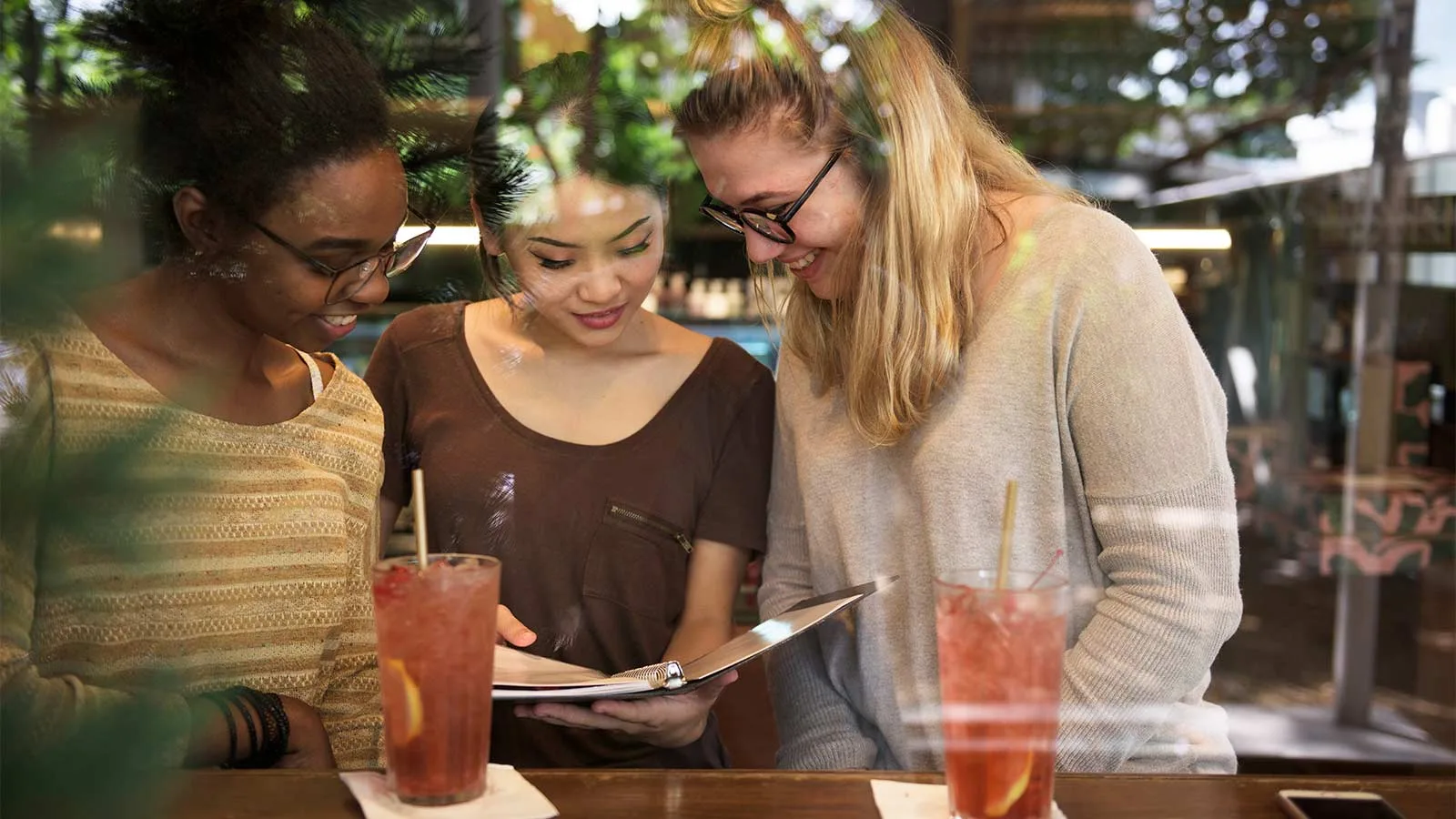 Women discussing the feedback they are going to leave to a restaurant